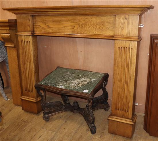 A reproduction oak fire surround, W.153cm H.124cm